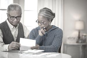 Older african american couple looking at paperwork together.